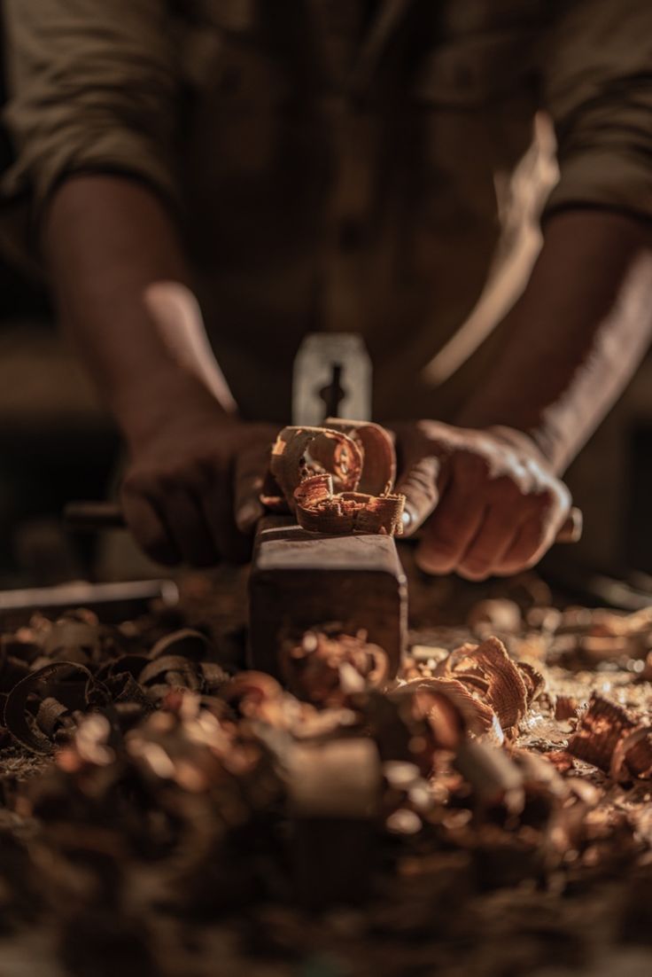 Artisan shaping a wood sculpture